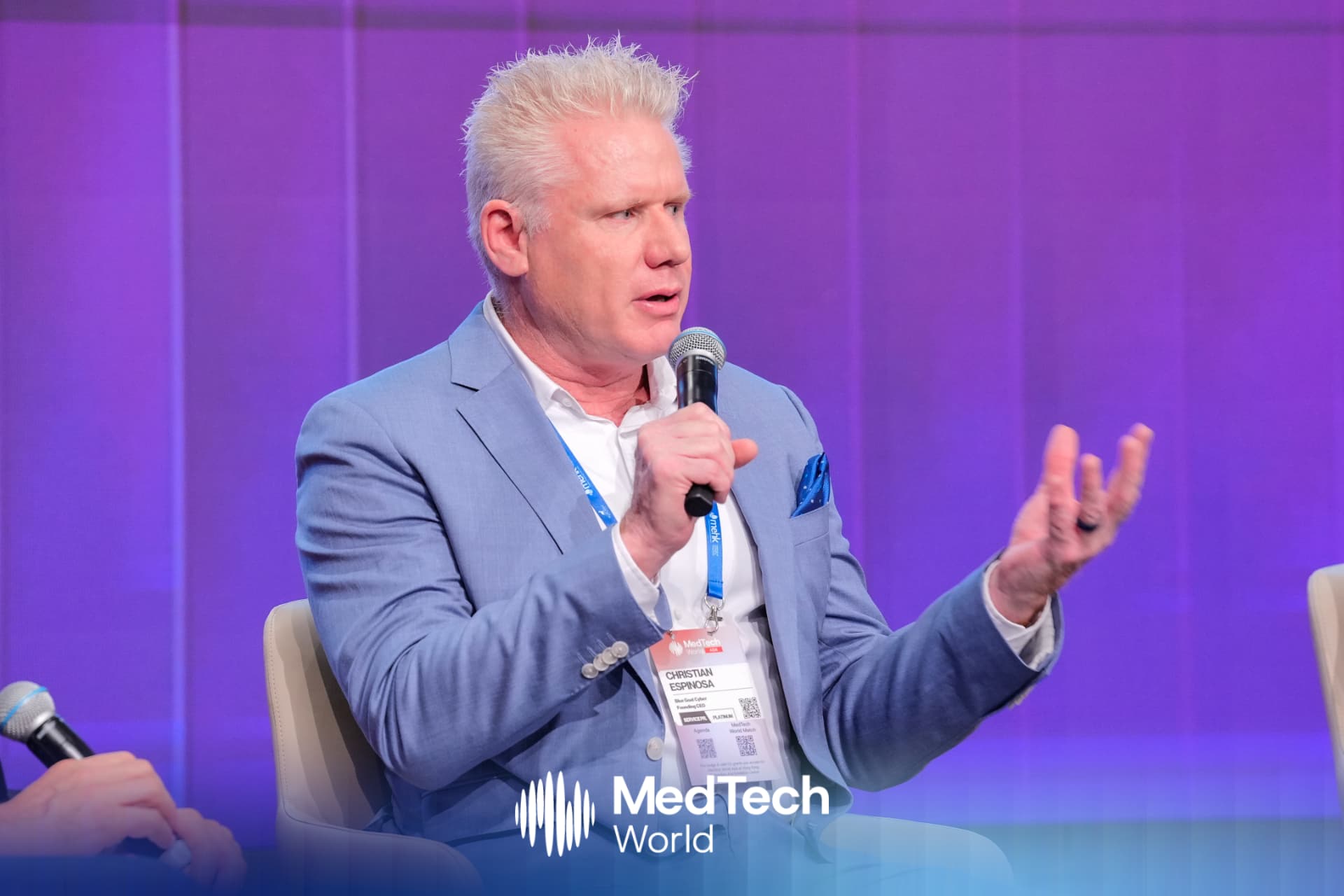 Christian Espinosa speaking with a microphone during a panel session at MedTech World Asia in Hong Kong