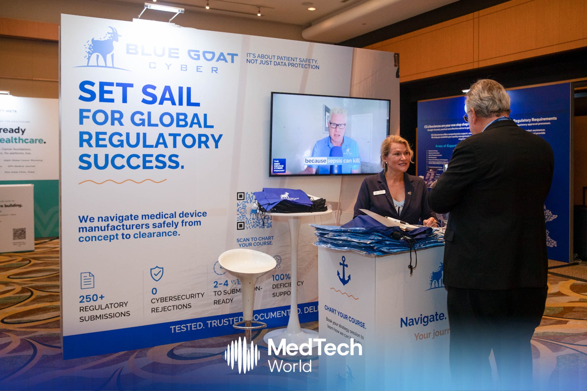 Melissa Espinosa talking with an attendee at the Blue Goat Cyber booth at MedTech World Asia in Hong Kong