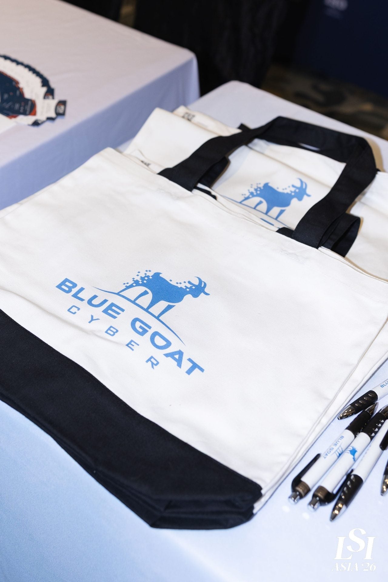 Blue Goat Cyber branded tote bags at the LSI Asia '26 sponsor booth in Singapore