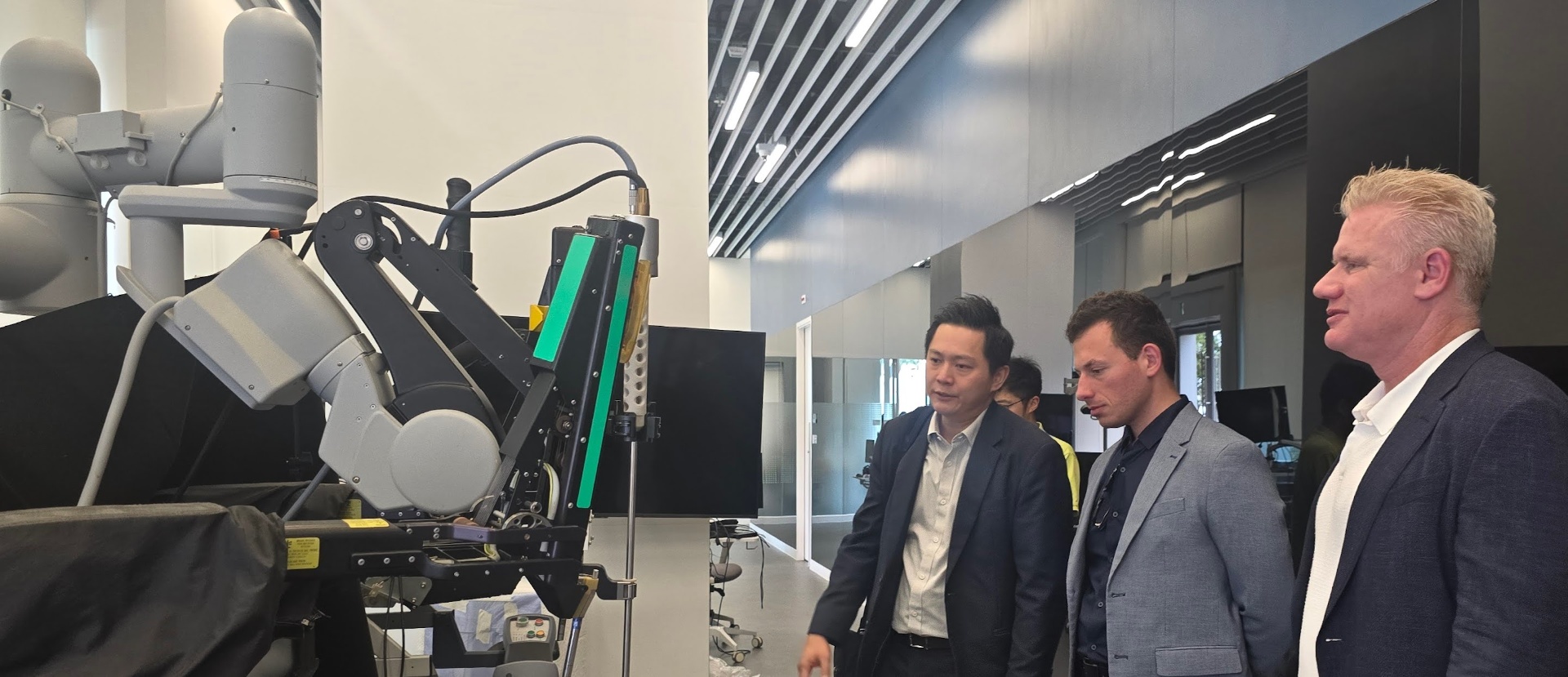 Christian Espinosa with a surgical robotics platform during a Hong Kong MedTech site visit