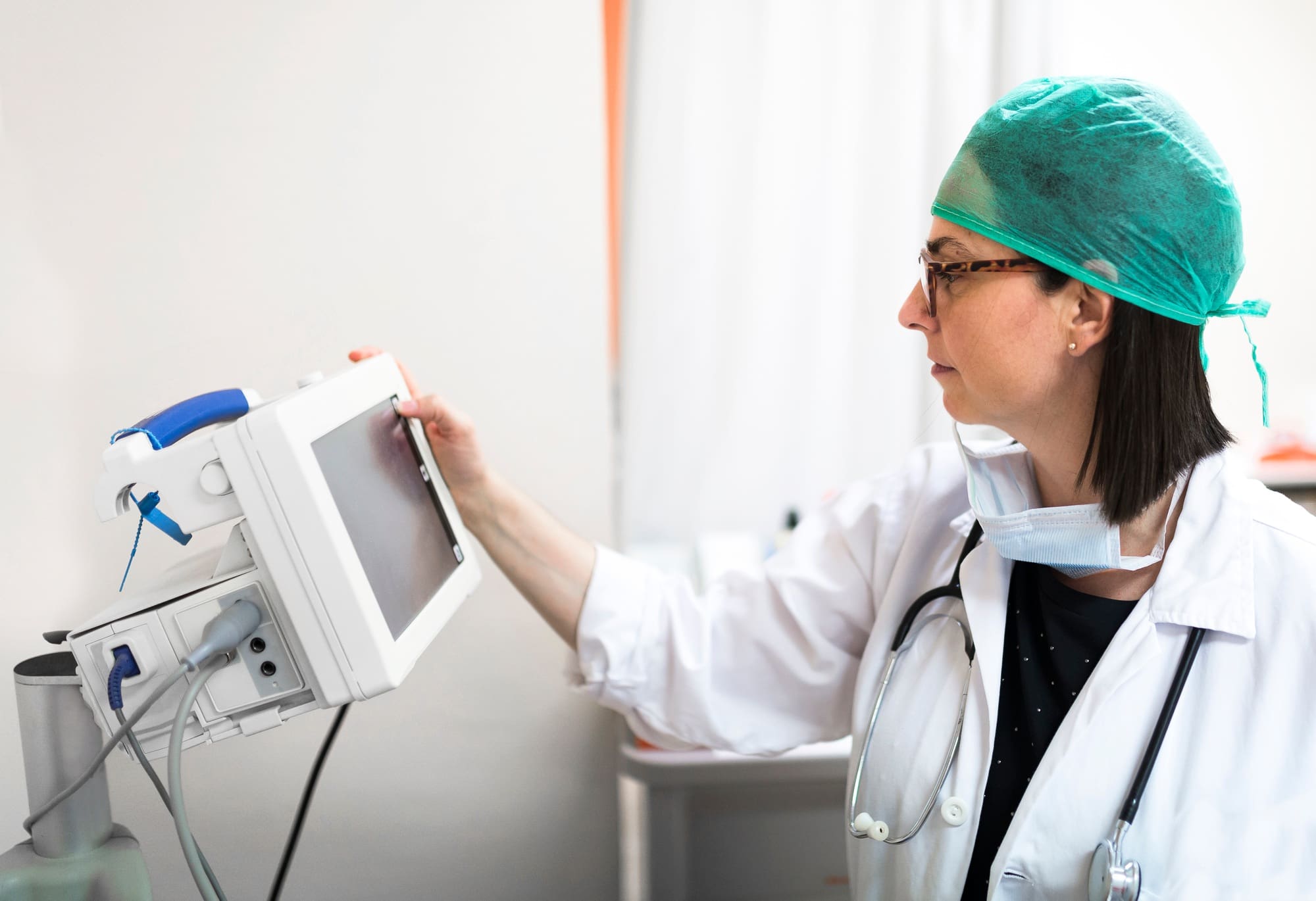 Doctor adjusting medical device