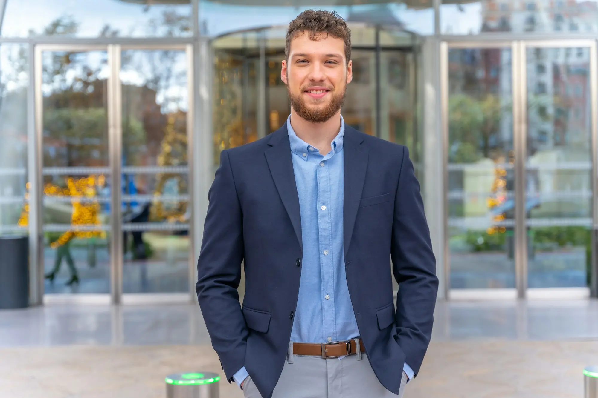 Portrait young businessman CEO of a company at the entrance of the office, finance concept